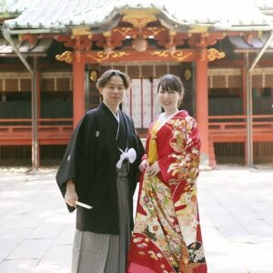 赤色のリメイク打掛を着た花嫁と花婿